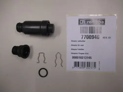 Remeha Adapter Entlüfter mit zwei gummierten Teilen, zwei kleinen Halterungen und einem O-Ring auf einer hellen Unterlage dargestellt.